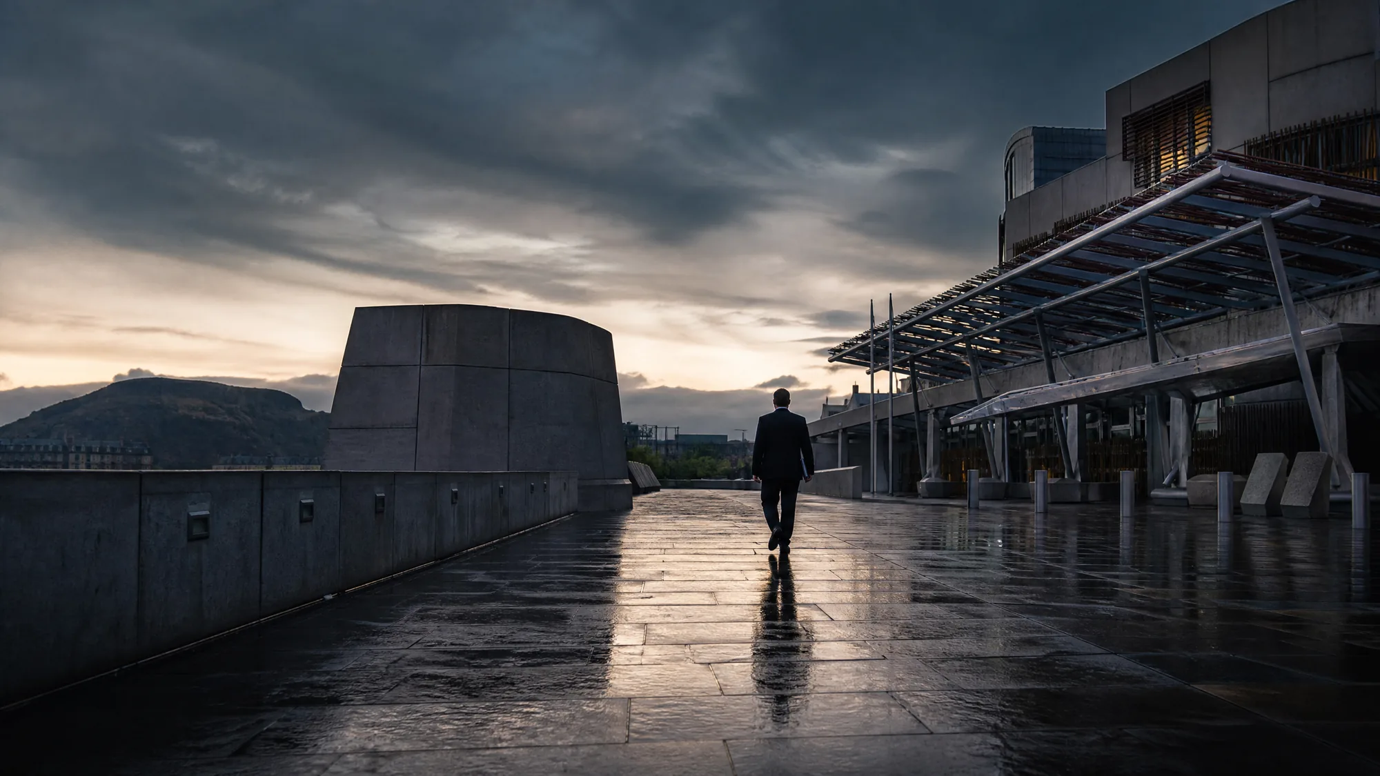 An anonymous suited figure walking away from a Scottish government building at dusk, symbolising political accountability.