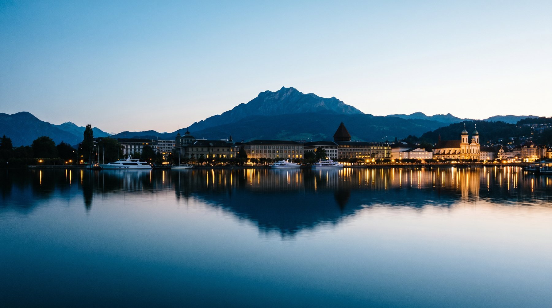 Lake Zug and Alpine silhouettes at blue hour — Switzerland