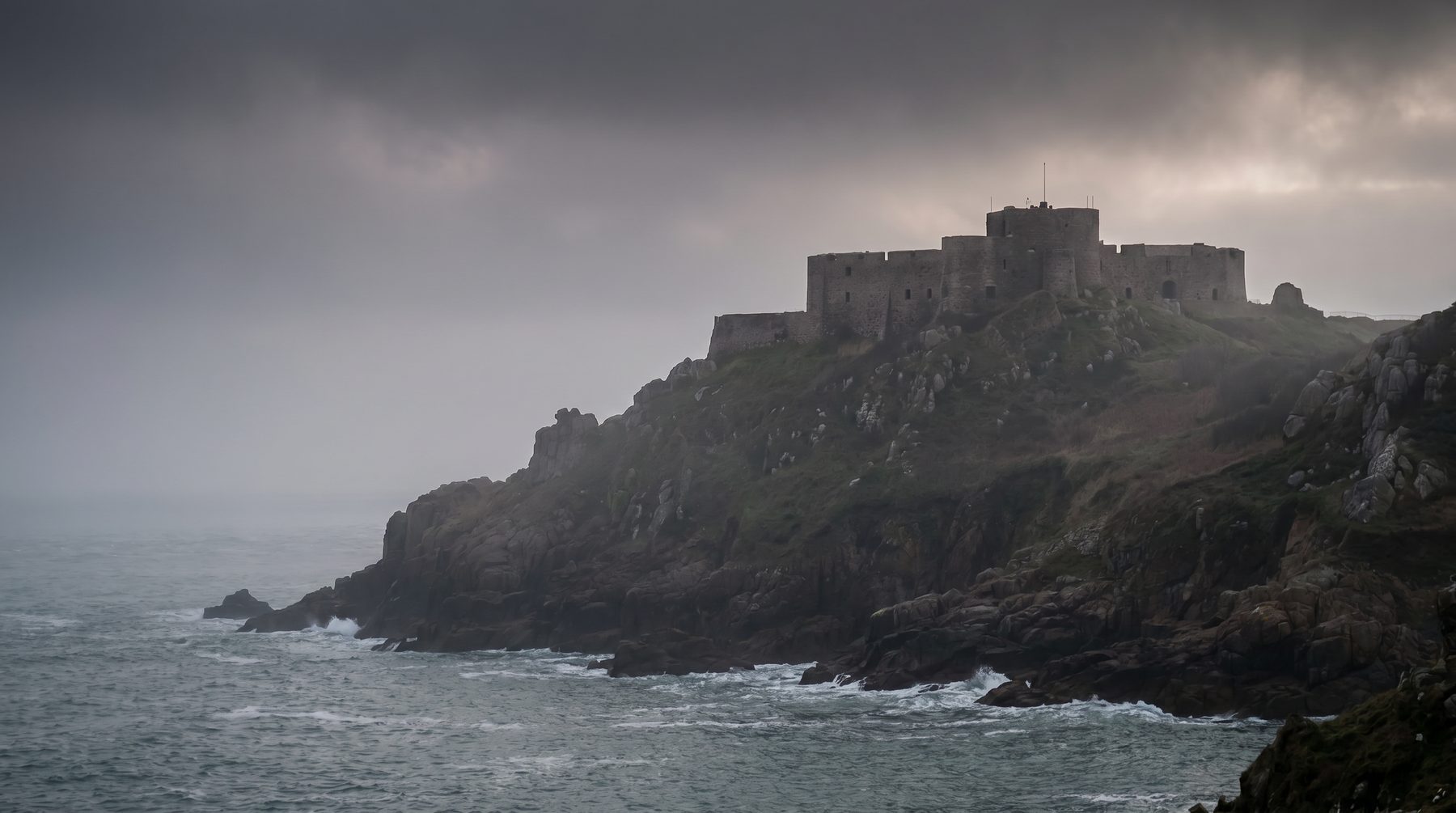 Medieval castle above tidal water — Jersey