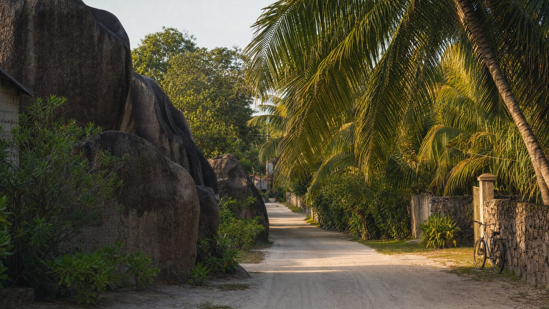 La Digue island road with granite boulders and palms