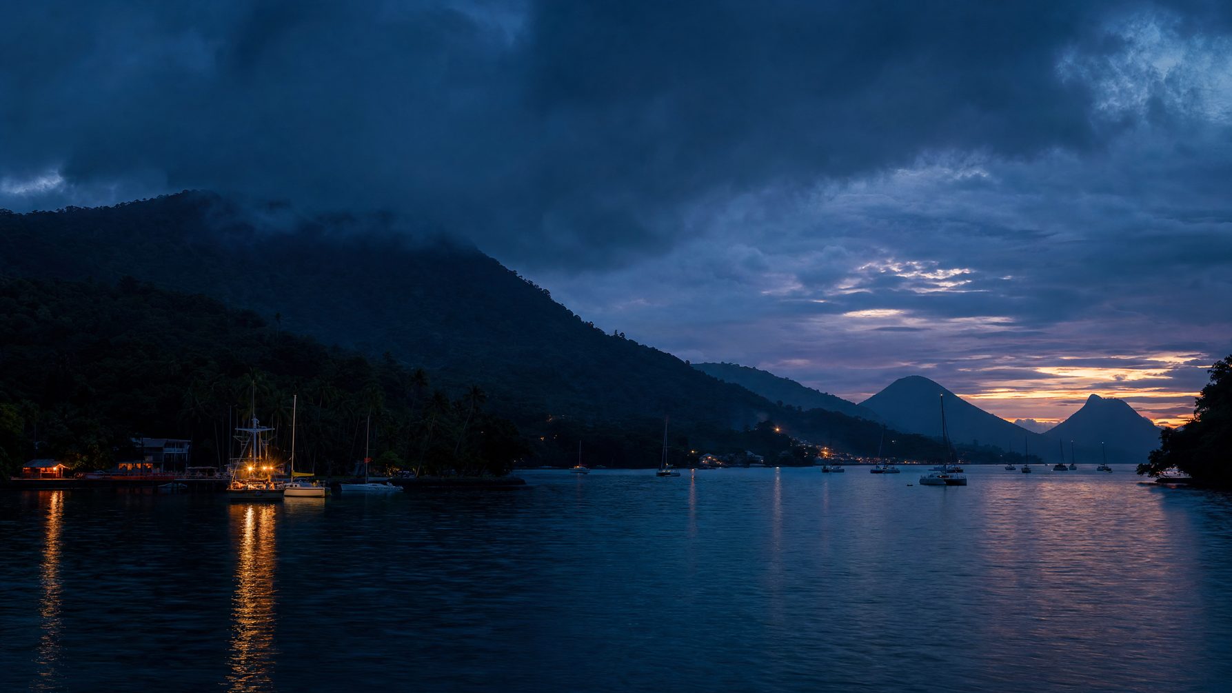 Vanuatu Pacific harbour and volcanic silhouettes at blue hour